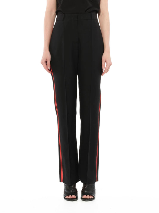Image of a model wearing Pants. Productname: GIVENCHY Podium Trousers in Black Red colour by brand - GIVENCHY