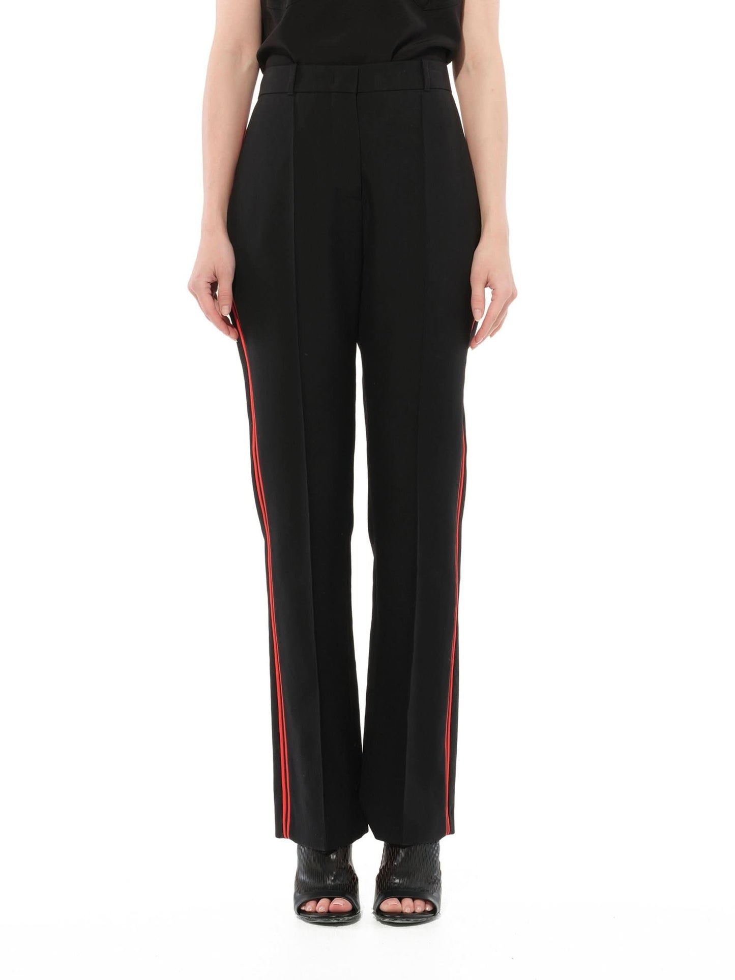 Image of a model wearing Pants. Product name - Podium Trousers in Black colour by brand - GIVENCHY