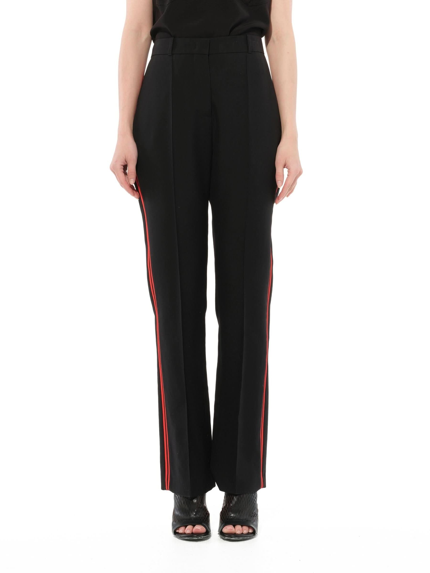 Image of a model wearing Pants. Product name - Podium Trousers in Black colour by brand - GIVENCHY