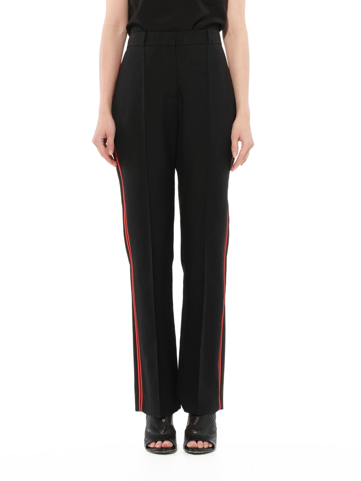 Image of a model wearing Pants. Product name - Podium Trousers in Black colour by brand - GIVENCHY