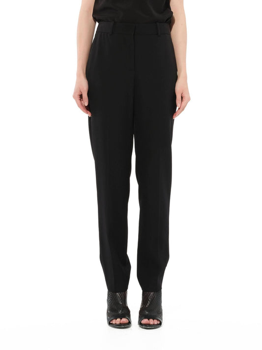 Image of a model wearing Pants. Productname: GIVENCHY Podium Trousers in Black colour by brand - GIVENCHY