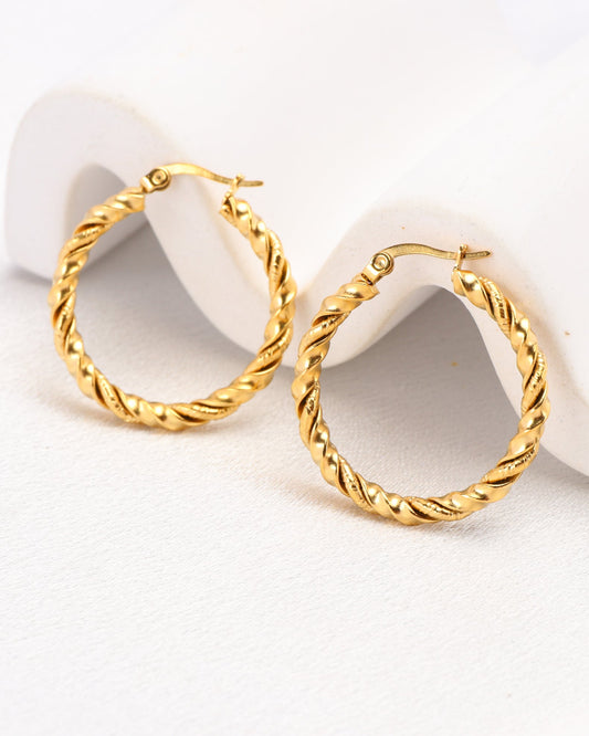 Image of Accessories. Productname: Charlotte Gold Twist Hoop Earrings in Gold colour by brand - Heychic