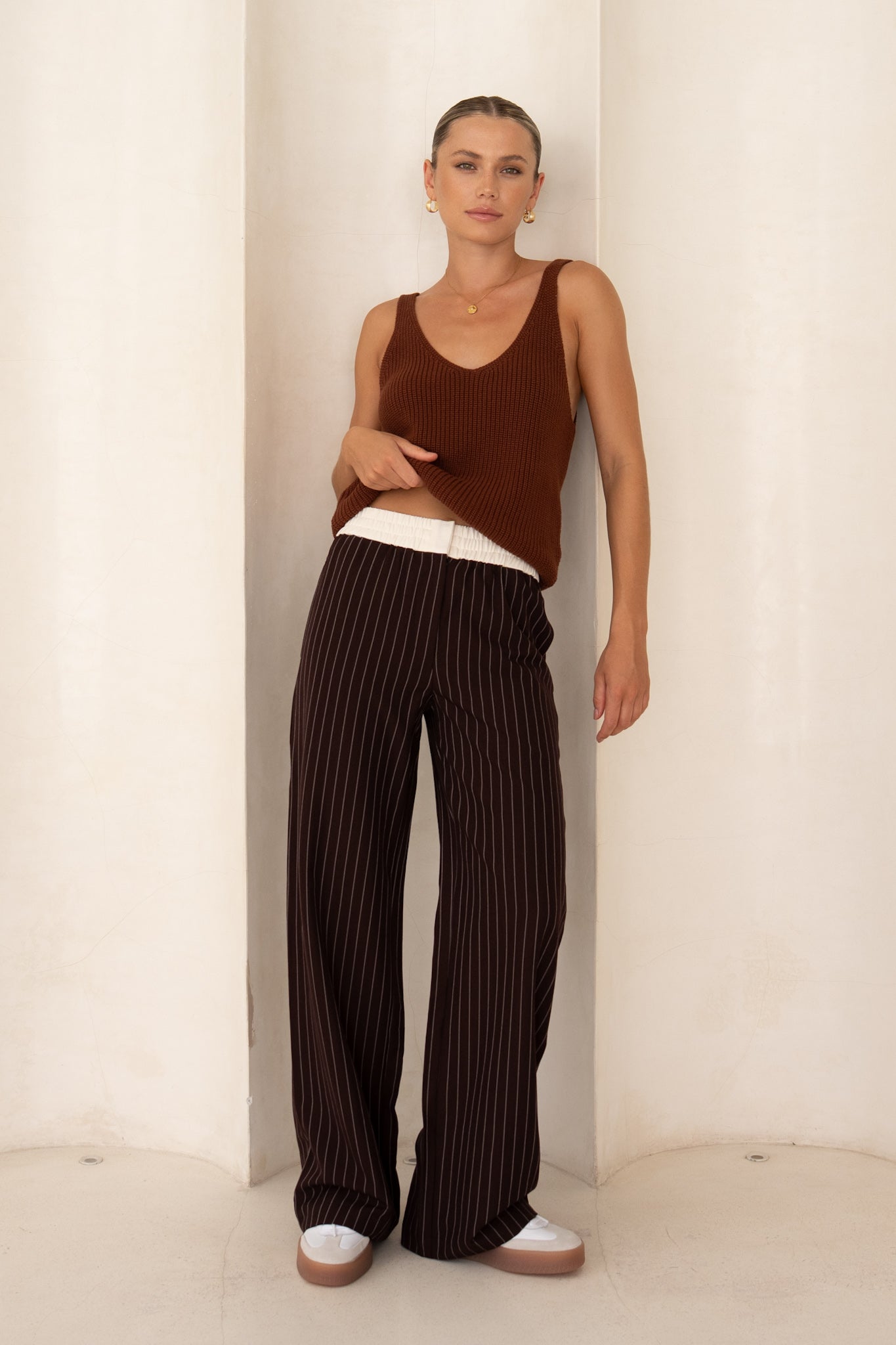 Image of a model wearing Pants. Product name - Kya Brown Stripe Pants in Brown colour by brand - HEYCHIC