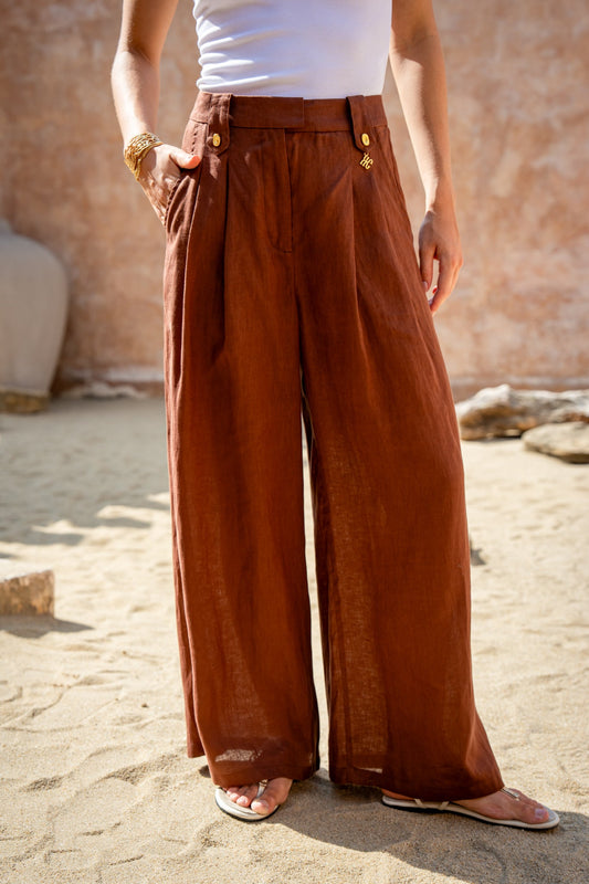 Image of a model wearing Pants. Product name - Cael Brown Linen Pants in Brown colour by brand - HEYCHIC