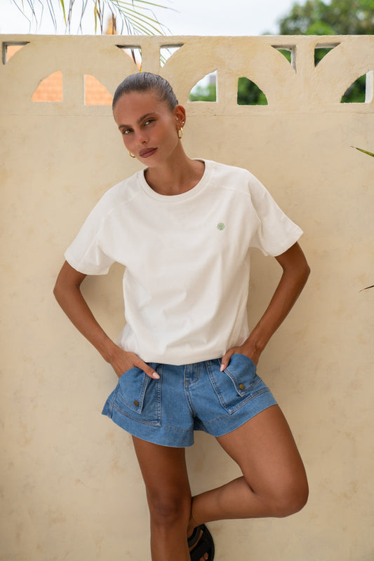 Image of a model wearing Tops. Product name - Zoe Motif White T-Shirt in White colour by brand - Heychic