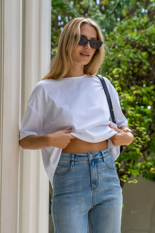 Image of a model wearing Tops. Productname: HEYCHIC Jos White Relaxed Fit T-Shirt in White colour by brand - HEYCHIC