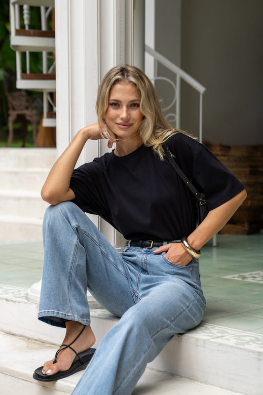 Image of a model wearing Tops. Productname: HEYCHIC Jos Black Relaxed Fit T-Shirt in Black colour by brand - HEYCHIC