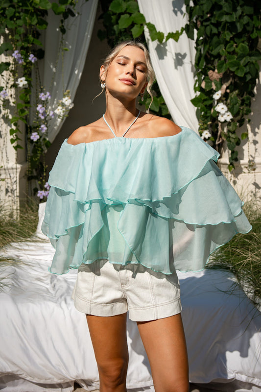 Image of a model wearing Tops. Product name - Vivie Green Layer Top in Green colour by brand - HEYCHIC