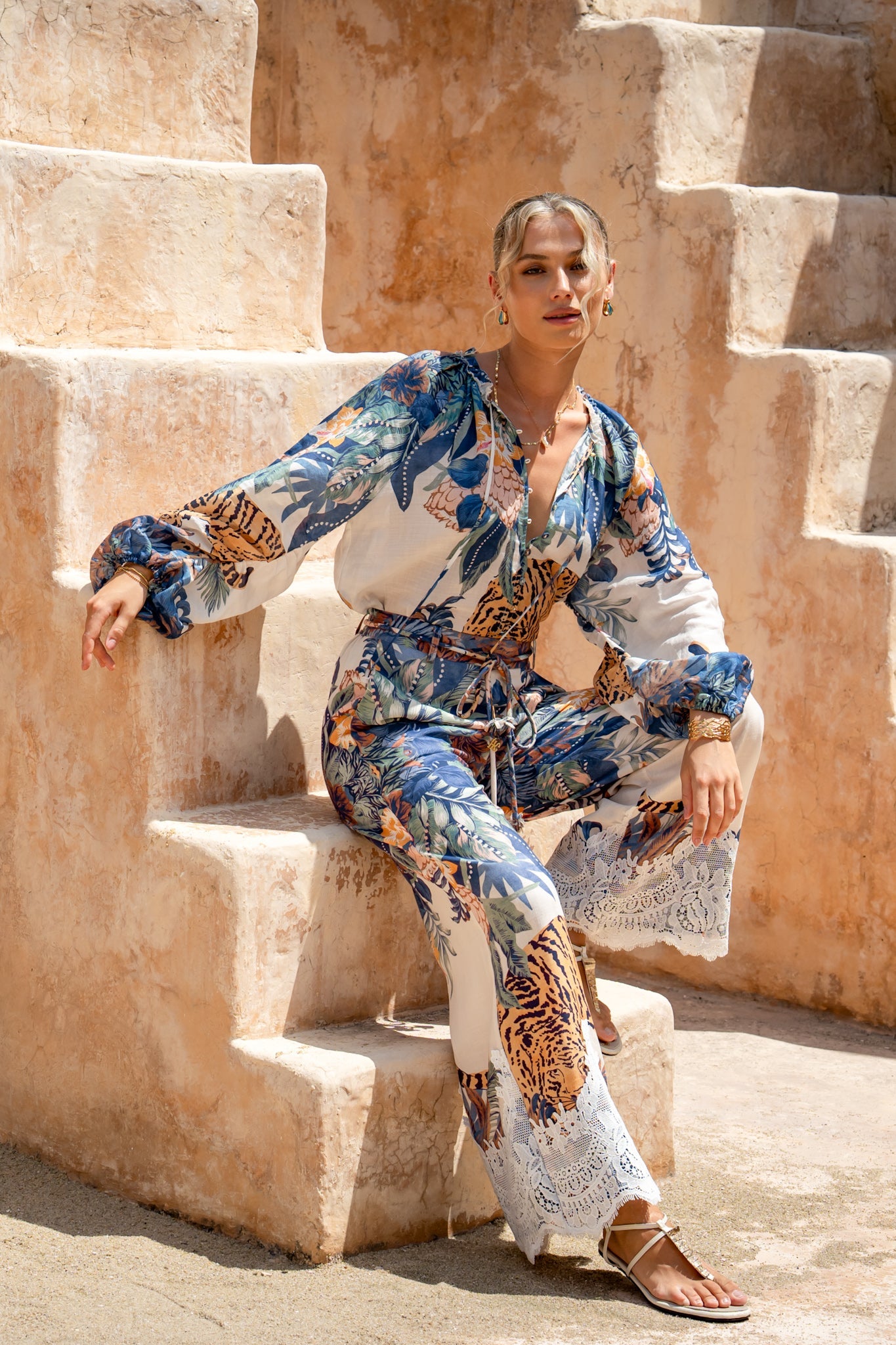 Image of a model wearing Pants. Product name - Wild Blue Tropical Pants in Blue colour by brand - HEYCHIC