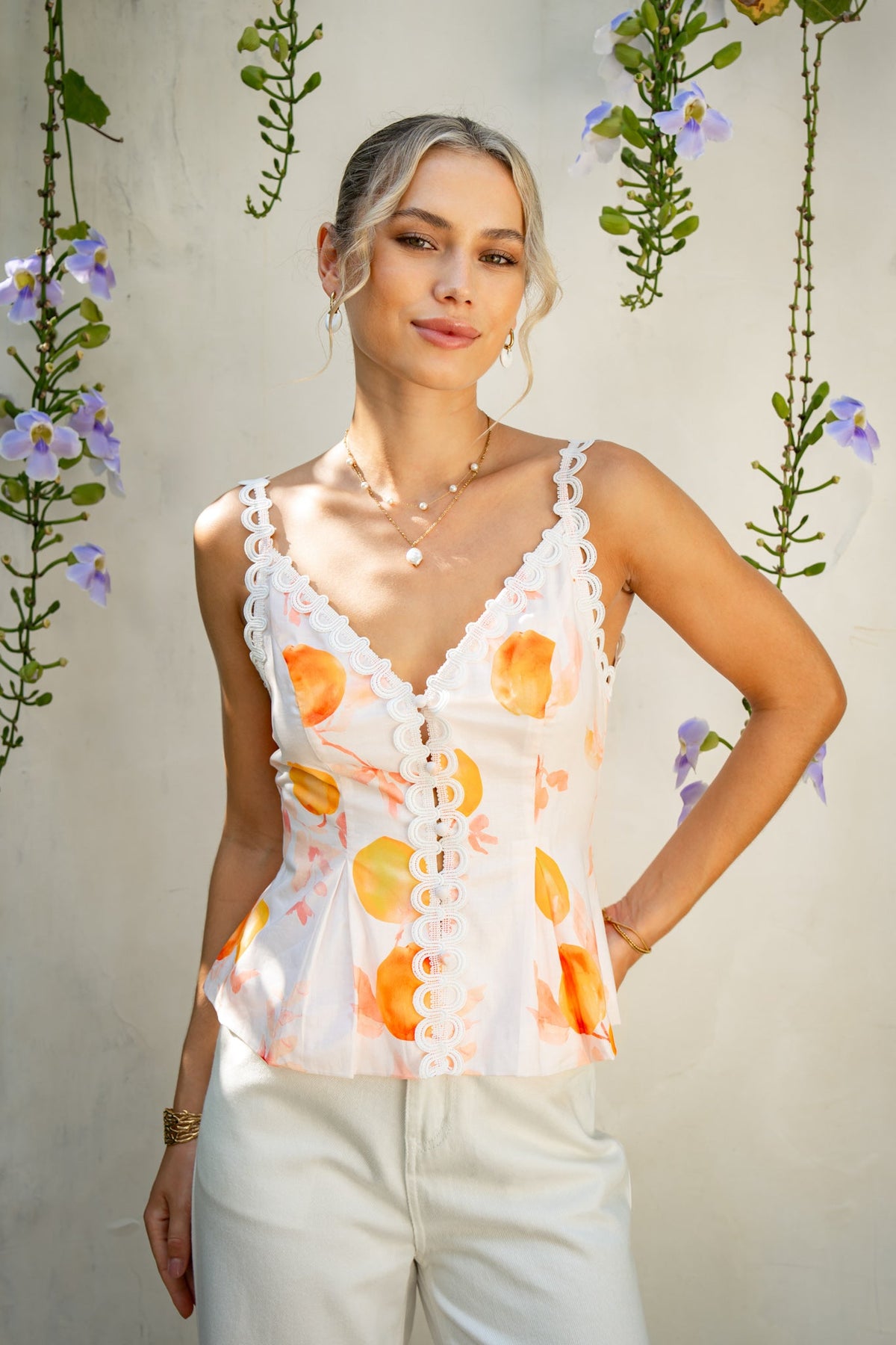 Image of a model wearing Tops. Product name - Peach Orchards Orange Cami Top in Orange colour by brand - HEYCHIC