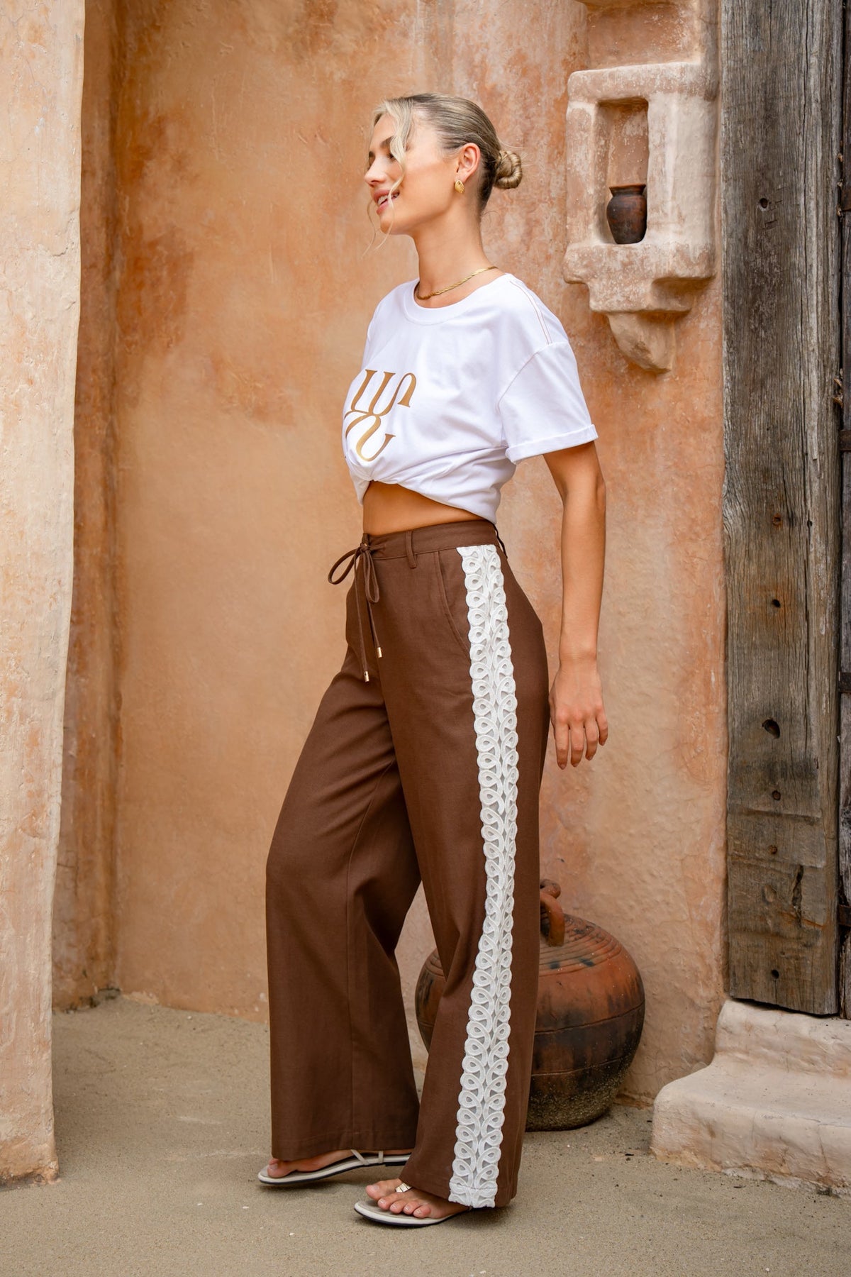 Image of a model wearing Pants. Product name - Jia Brown Lace Detail Pants in Brown colour by brand - HEYCHIC