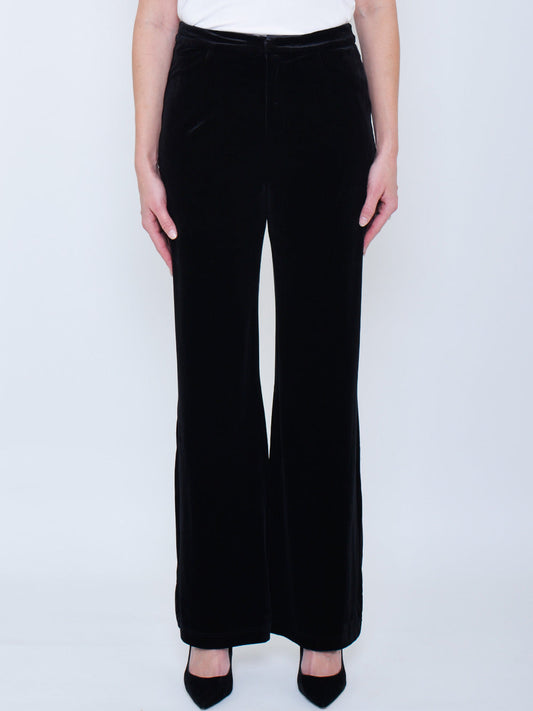 Image of a model wearing Pants. Product name - YELTUOR X HANSEN & GRETEL BOWIE VELVET PANT in Black colour by brand - Hansen & Gretel