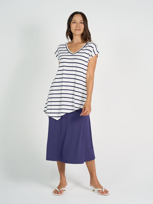 Image of a model wearing Tops. Product name - Holiday Asymmetrical Bamboo V-Neck T-Shirt Blue & White Stripe in Blue & White Stripe colour by brand - Lou Lou