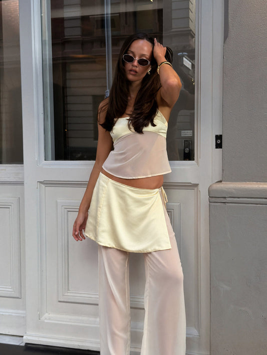 Image of a model wearing Pants. Productname: SNDYS ZOE WRAP PANTS in Butter colour by brand - SNDYS