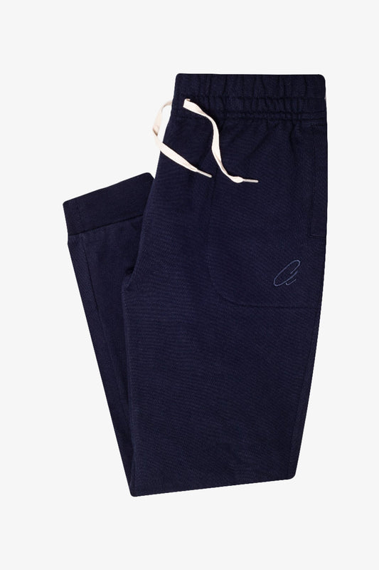 Image of a model wearing Outerwear. Product name - Gilroy Navy Sweat Pants in Navy colour by brand - Anthony Squires