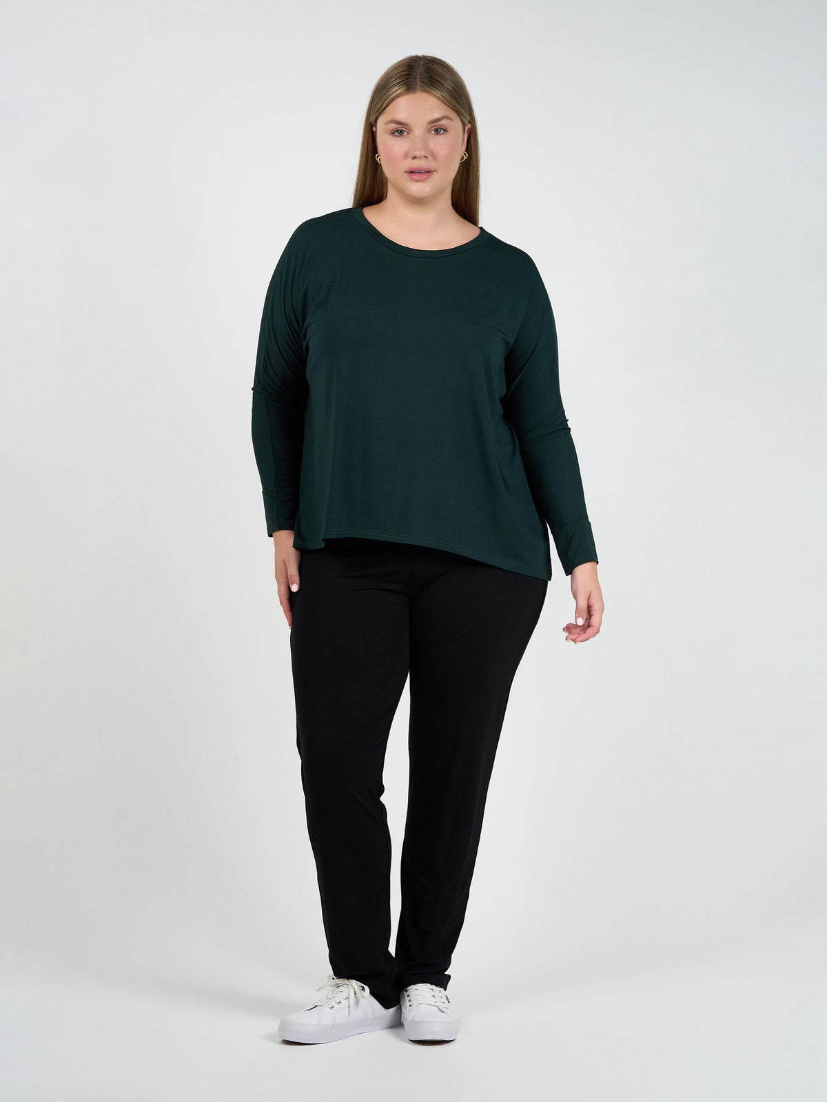 Image of a model wearing Tops. Product name - Gina Long Sleeved Bamboo Top Dark Green in Dark Green colour by brand - Lou Lou