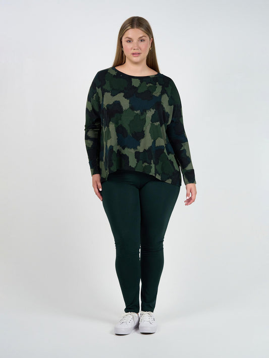 Image of a model wearing Tops. Product name - Gina Long Sleeved Bamboo Top Camouflage in Camouflage colour by brand - Lou Lou