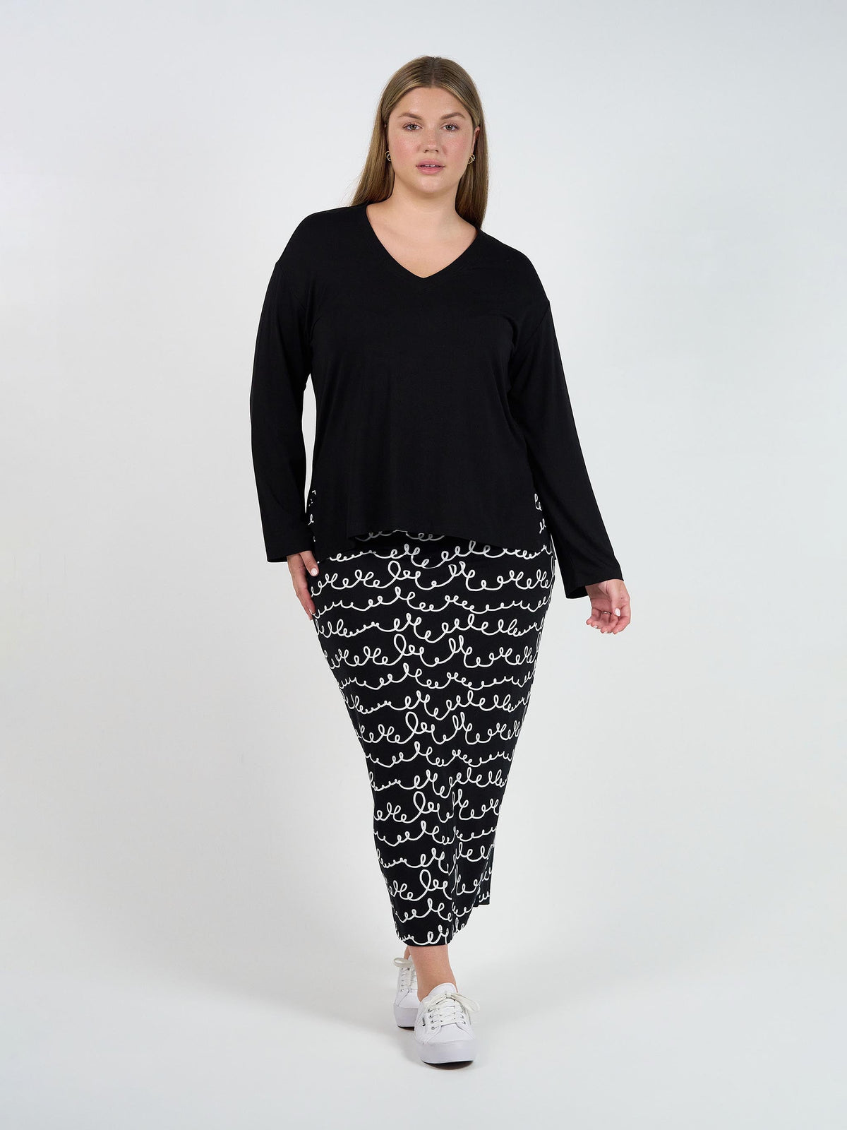 Image of a model wearing Tops. Product name - Braxton Bamboo Long Sleeve Top Black in Black colour by brand - Lou Lou