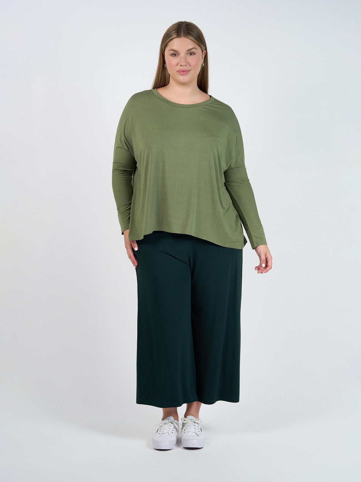 Image of a model wearing Tops. Product name - Gina Long Sleeved Bamboo Top Olive in Olive colour by brand - Lou Lou