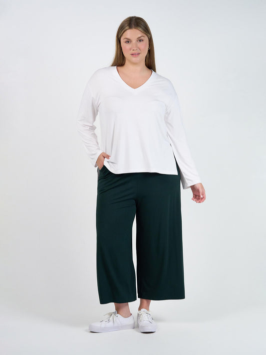Image of a model wearing Pants. Product name - Ciara 7/8 Length Bamboo Culottes- Dark Green in Dark Green colour by brand - Lou Lou
