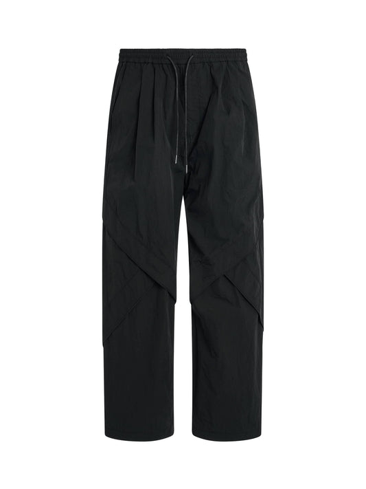 Image of a model wearing Pants. Productname: JUUNJ Nylon Piped Pants in BLACK colour by brand - JUUNJ