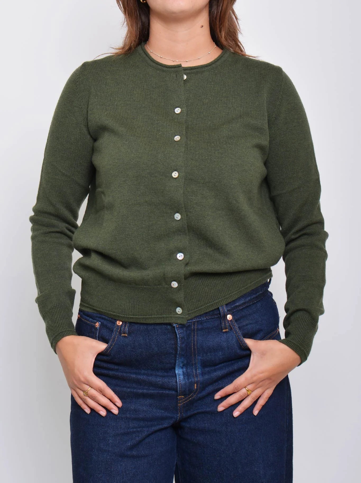Image of a model wearing Outerwear. Product name - JAMES MELBOURNE PERFECT LITTLE CARDI in Olive colour by brand - James Melbourne