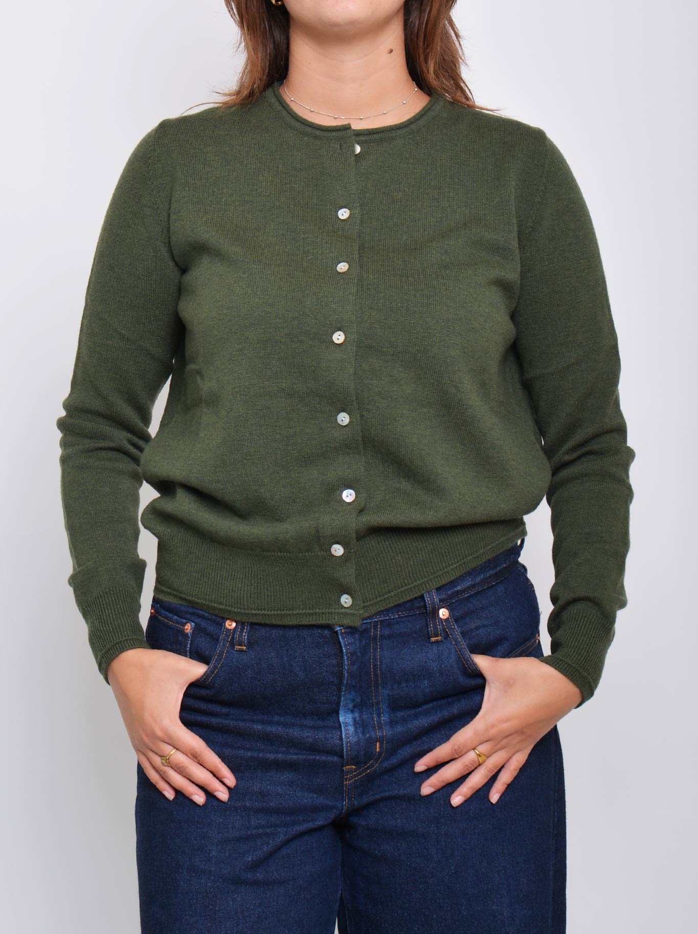 Image of a model wearing Outerwear. Product name - JAMES MELBOURNE PERFECT LITTLE CARDI in Olive colour by brand - James Melbourne