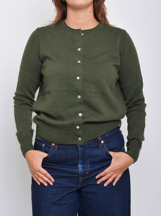 Image of a model wearing Outerwear. Product name - JAMES MELBOURNE PERFECT LITTLE CARDI in Olive colour by brand - James Melbourne