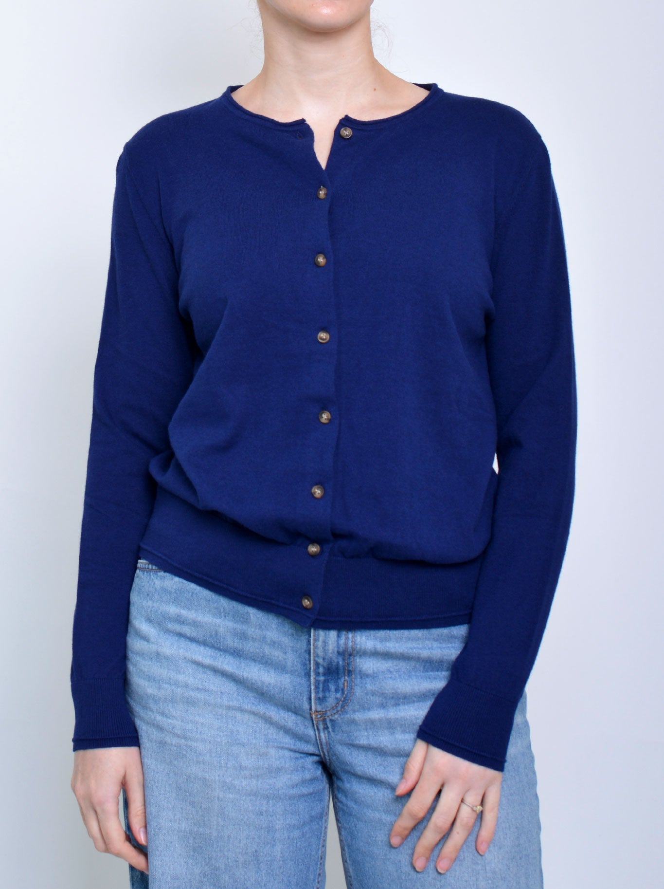 Image of a model wearing Outerwear. Product name - JAMES MELBOURNE PERFECT CARDI in Navy A colour by brand - James Melbourne