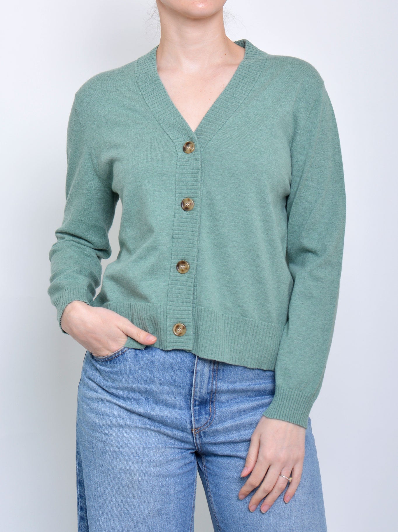 Image of a model wearing Outerwear. Product name - James Melbourne Vee Button Cardi in Green colour by brand - James Melbourne