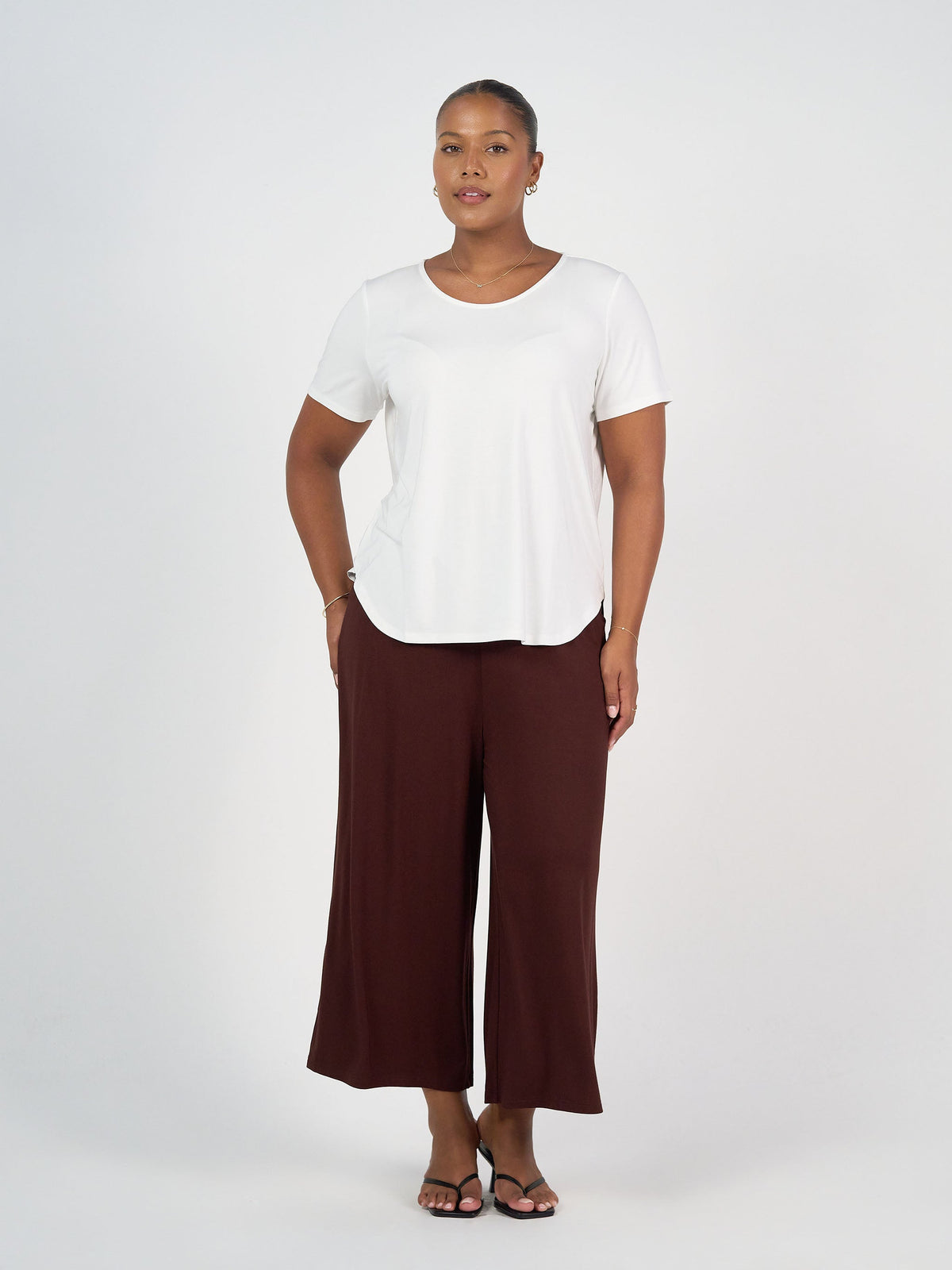 Image of a model wearing Tops. Product name - Janis Short Sleeve Bamboo T-Shirt Cream in Cream colour by brand - Lou Lou
