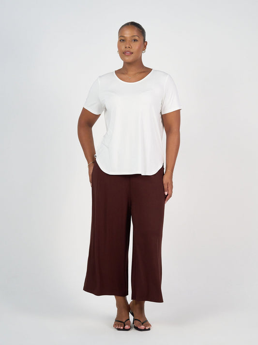 Image of a model wearing Tops. Product name - Janis Short Sleeve Bamboo T-Shirt Cream in Cream colour by brand - Lou Lou