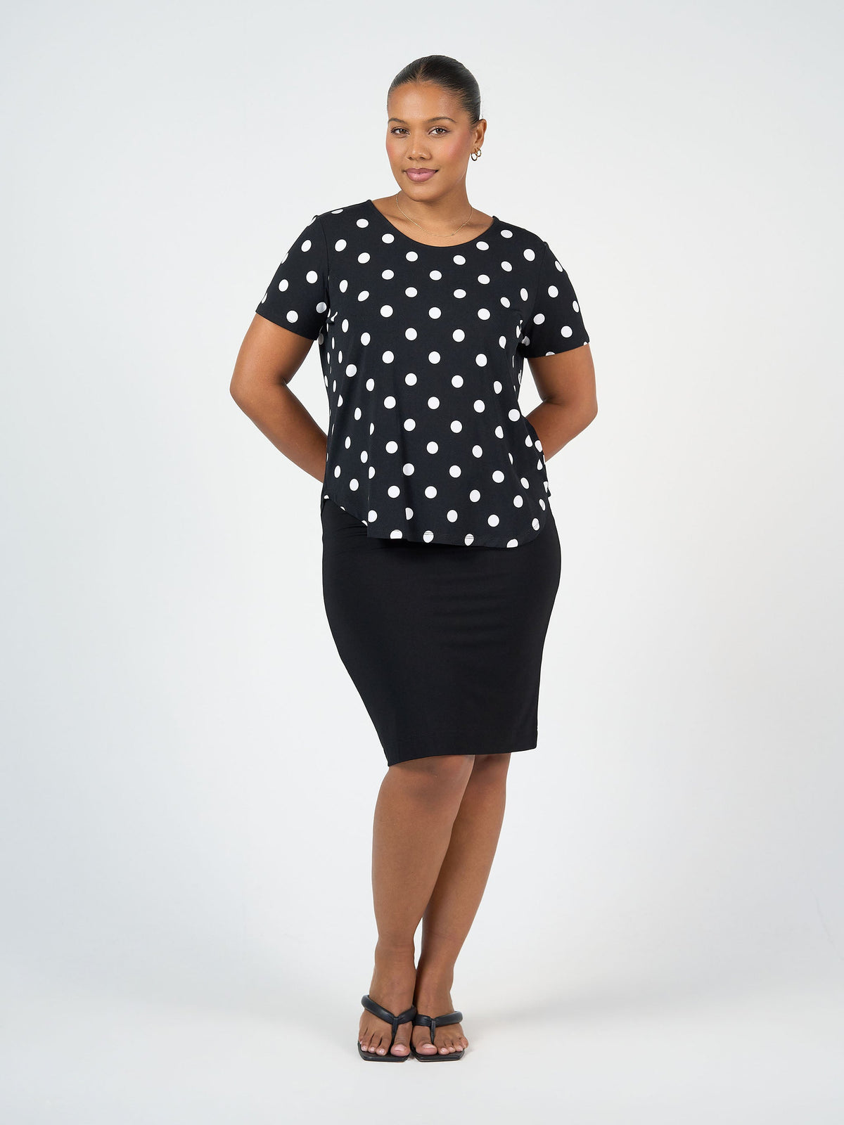 Image of a model wearing Tops. Product name - Janis Short Sleeve Bamboo T-Shirt Polka Dot in Polka Dot colour by brand - Lou Lou