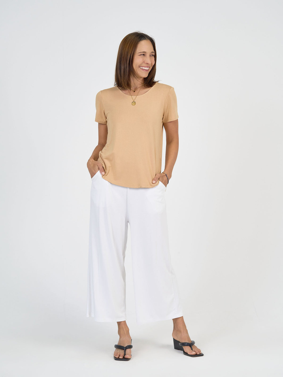 Image of a model wearing Tops. Product name - Janis Short Sleeve Bamboo T-Shirt Tan in Tan colour by brand - Lou Lou