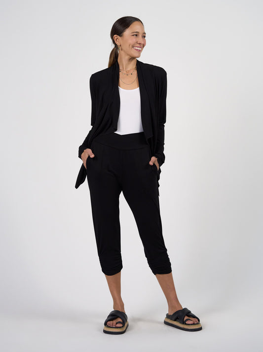 Image of a model wearing Pants. Product name - Perry Bamboo Cropped Pants in Black colour by brand - Lou Lou