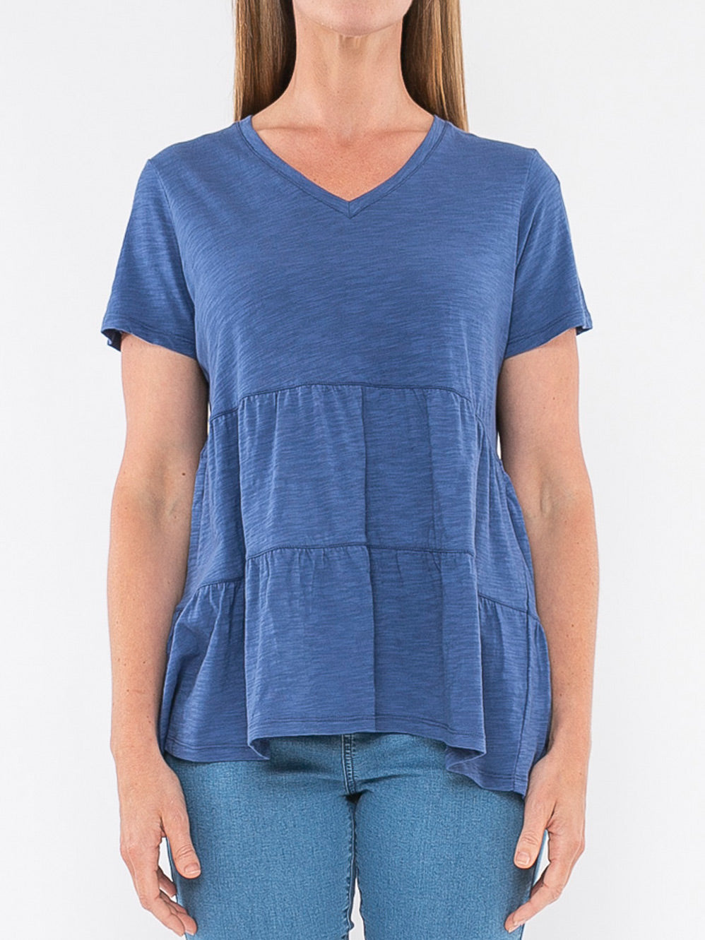 Image of a model wearing Tops. Productname: JUMP VEE NECK TIERED TEE in Emerald colour by brand - Jump