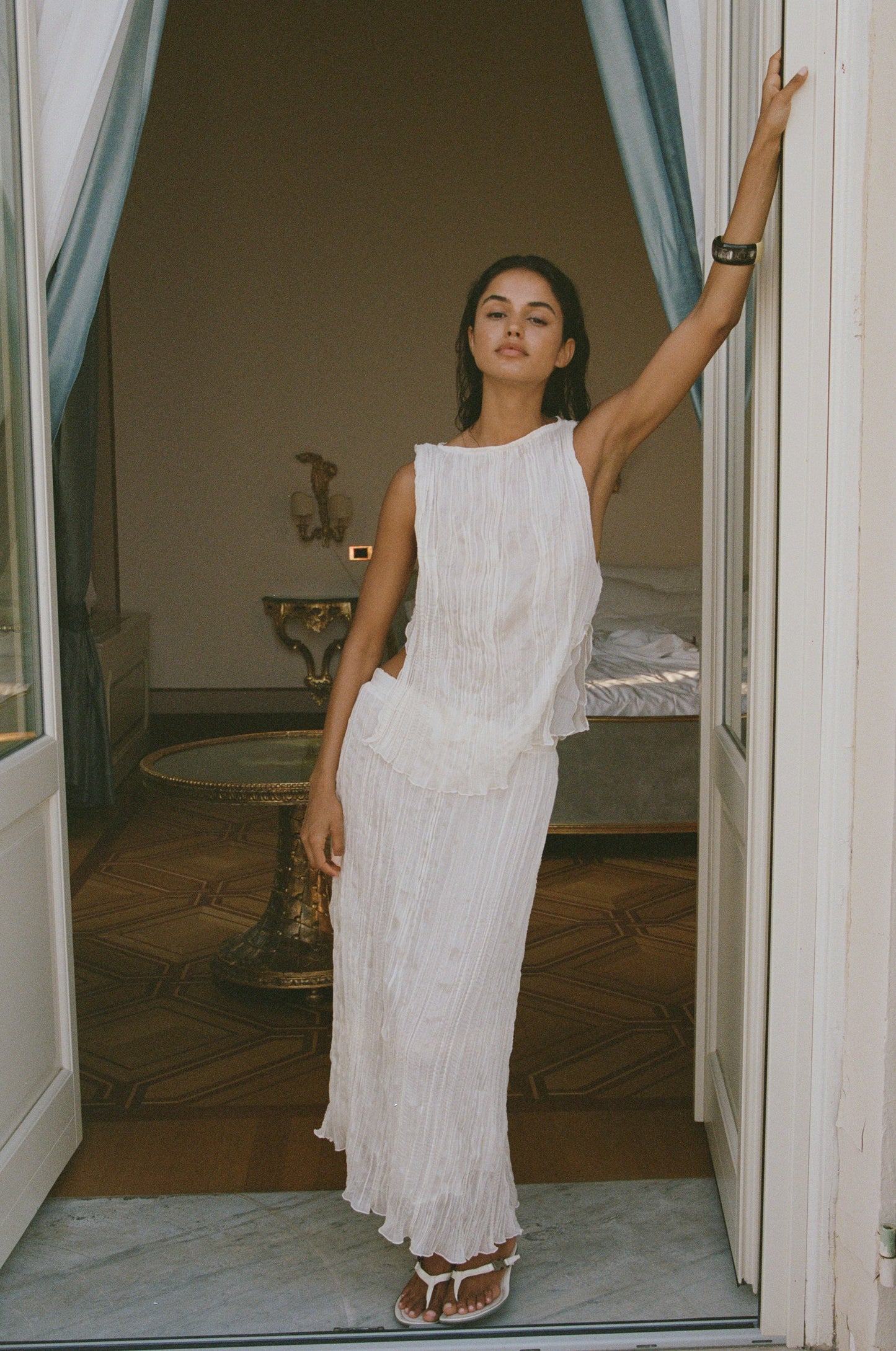 Image of a model wearing Skirts. Product name - Kea Midi Skirt in Cream colour by brand - With Jéan