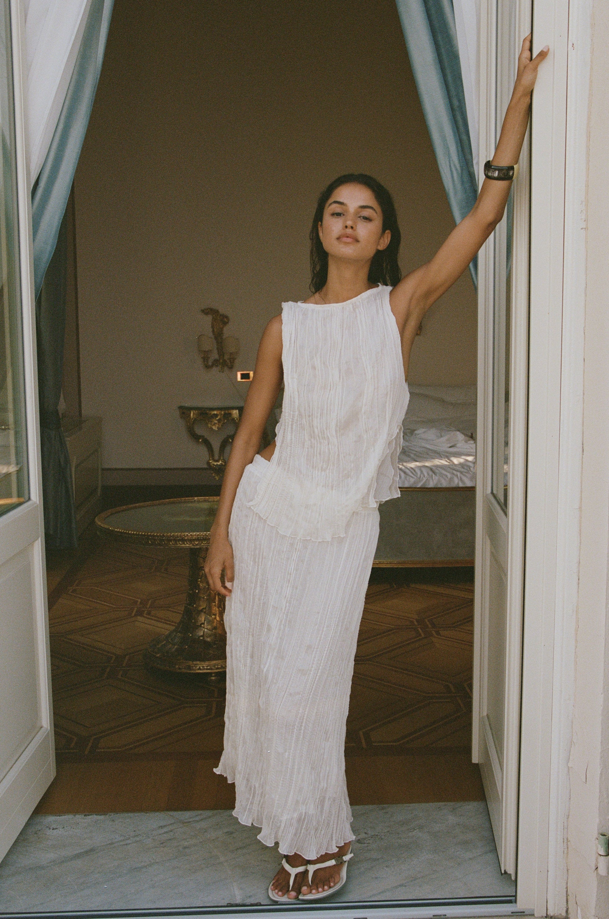 Image of a model wearing Skirts. Product name - Kea Midi Skirt in Cream colour by brand - With Jéan