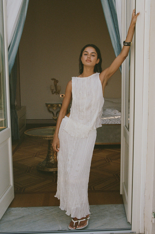 Image of a model wearing Skirts. Product name - Kea Midi Skirt in Cream colour by brand - With Jéan