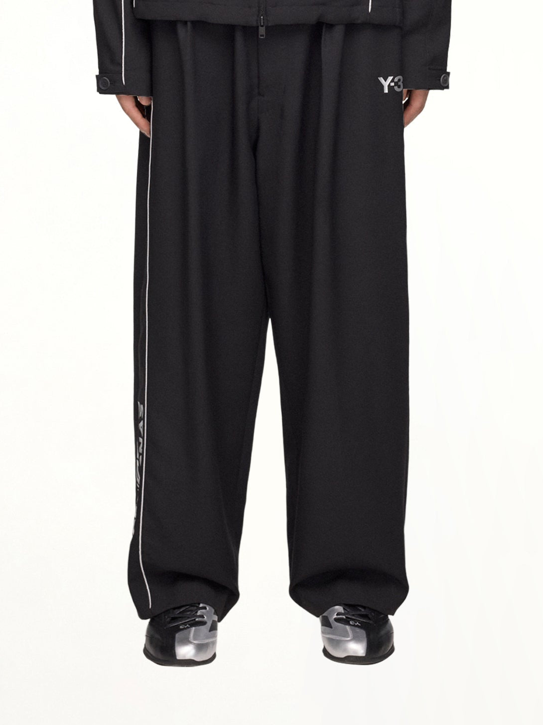 Image of a model wearing Pants. Product name - F1 Track Pants in Black colour by brand - Y-3