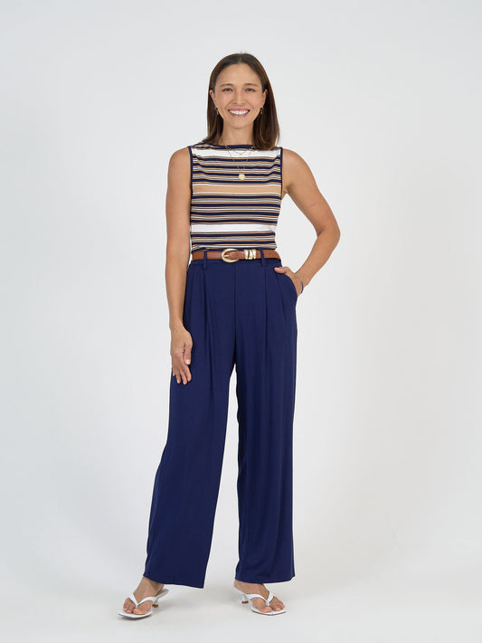 Image of a model wearing Pants. Product name - Billie Bamboo Wide Leg Dress Pant Navy in Navy colour by brand - Lou Lou