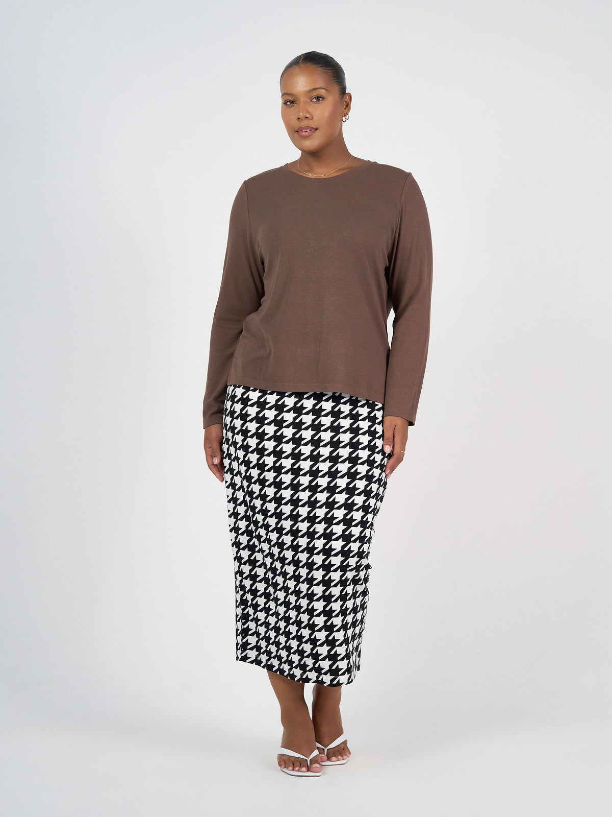 Image of a model wearing Tops. Product name - Kelly Ribbed Long Sleeve Bamboo Top in Chocolate colour by brand - Lou Lou
