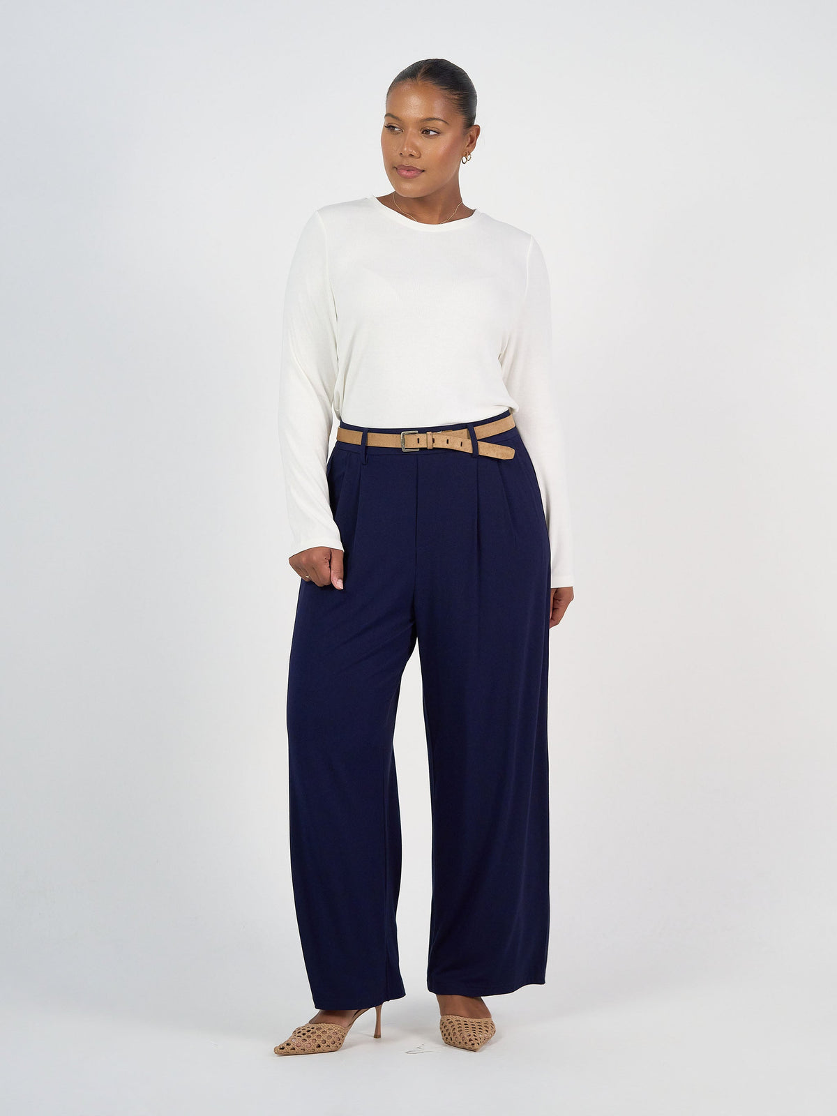 Image of a model wearing Tops. Product name - Kelly Ribbed Long Sleeve Bamboo Top Cream in Cream colour by brand - Lou Lou