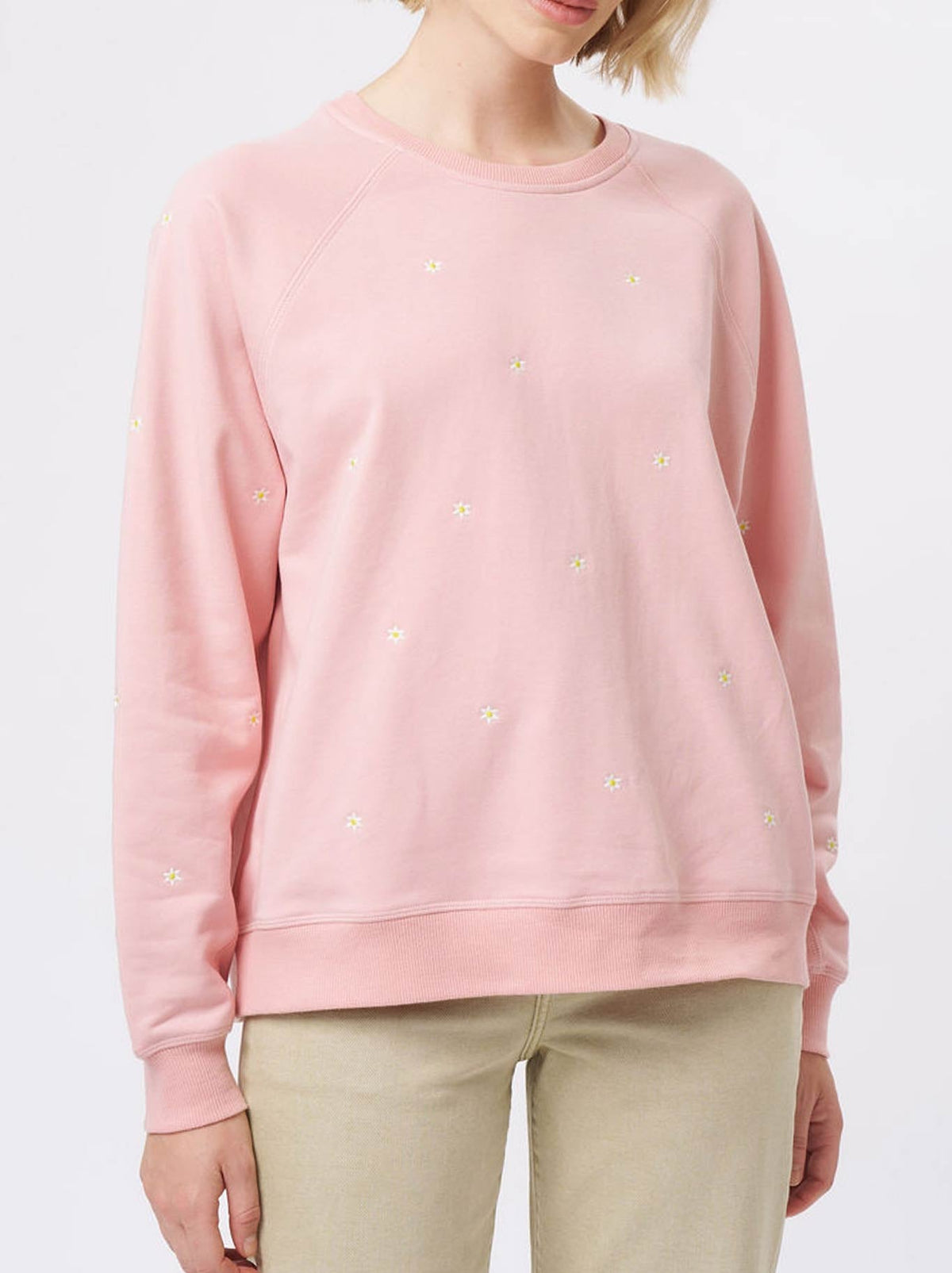 Image of a model wearing Tops. Product name - Kireina Patti Sweatshirt in Musk Pink Daisy colour by brand - Kireina