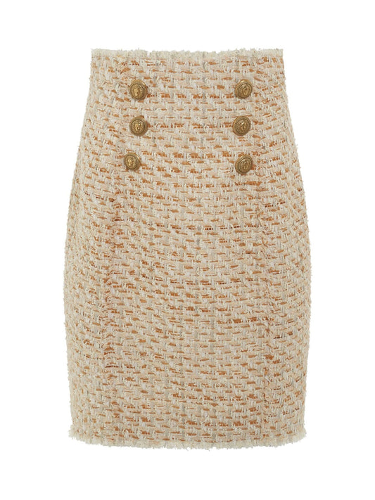 Image of a model wearing Shorts. Productname: BALMAIN High Waisted 6 Button Tweed Short Skirt in Multi Beige colour by brand - BALMAIN