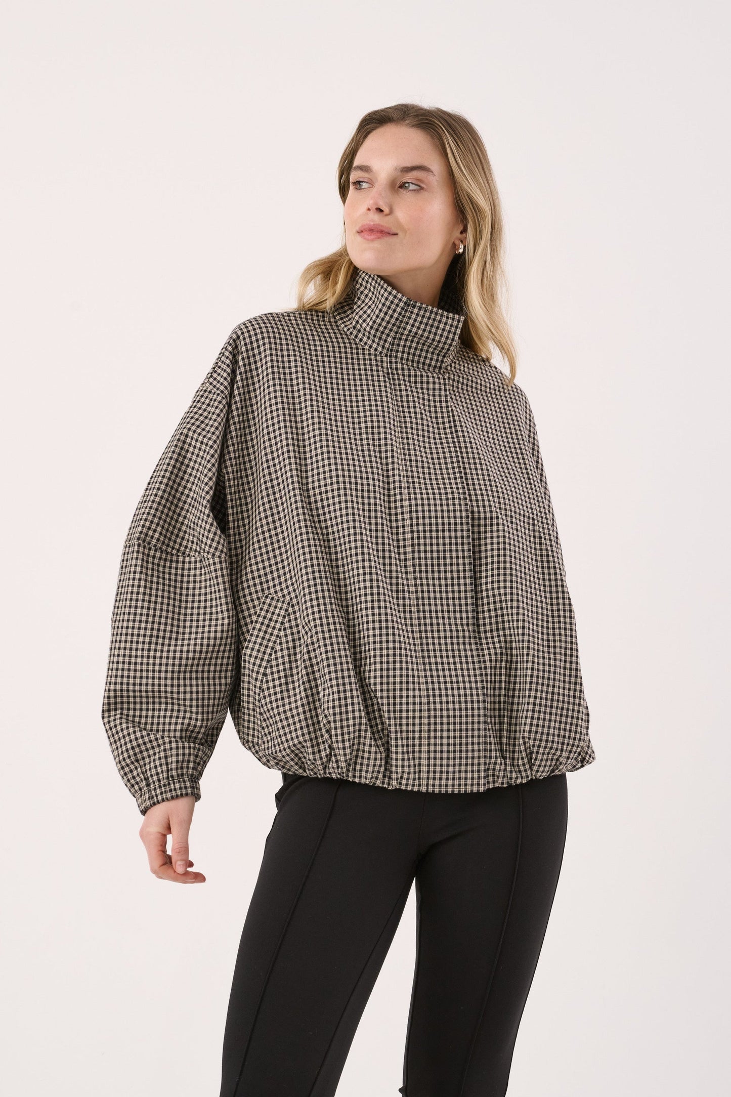 Image of a model wearing Outerwear. Product name - Sammie Bomber Jacket in Camel Check colour by brand - Sass Clothing