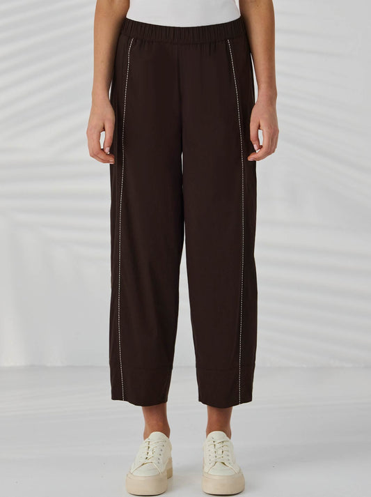 Image of a model wearing Pants. Product name - Lania The Label Barrel Pant in Cocoa colour by brand - Lania The Label