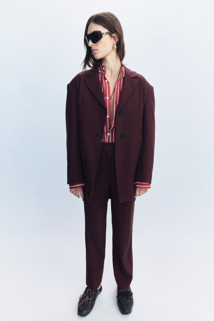 Image of a model wearing Outerwear. Product name - Lazara Blazer Burgundy in Burgundy colour by brand - Blanca Studio
