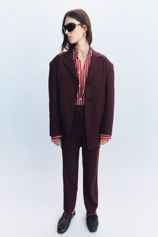 Image of a model wearing Outerwear. Product name - Lazara Blazer Burgundy in Burgundy colour by brand - Blanca Studio