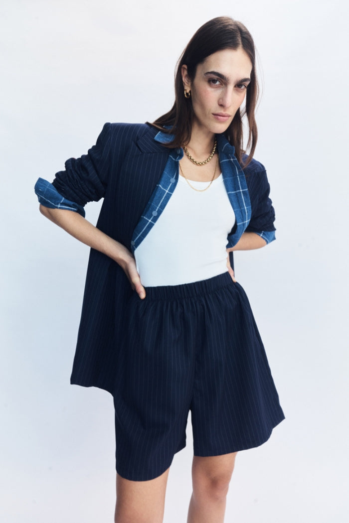 Image of a model wearing Shorts. Product name - Lazara Shorts Navy in Navy colour by brand - Blanca Studio